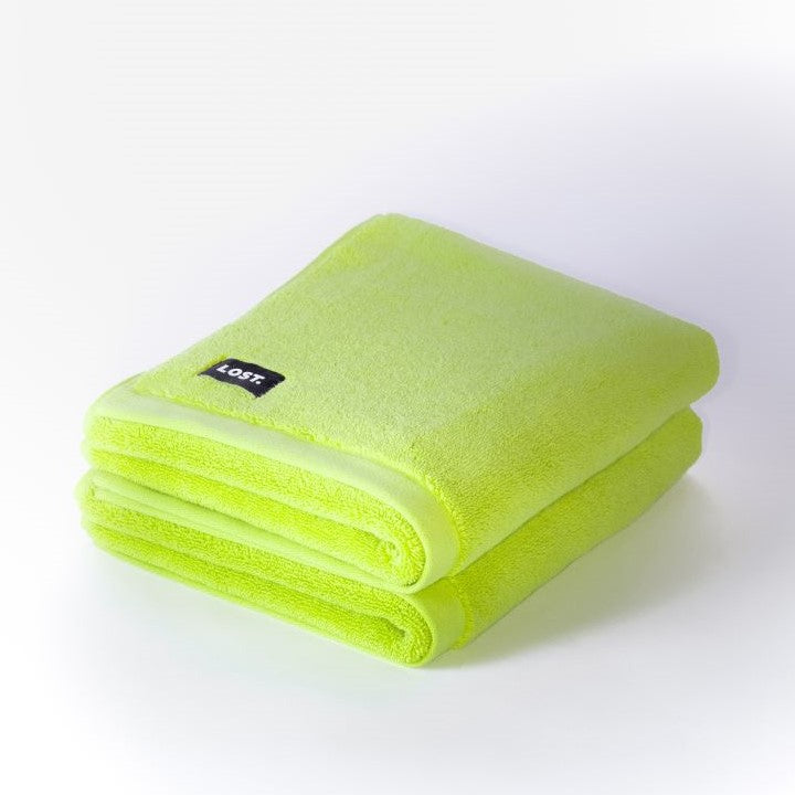 two folded chartreuse bath mats