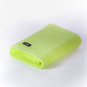 Folded chartreuse bath towel