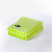 two folded chartreuse hand towels