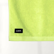 Lost Towel logo on a chartreuse bath towel 