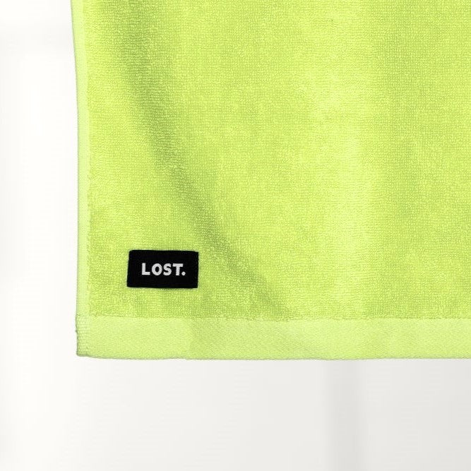 Lost Towel logo on a chartreuse bath towel 