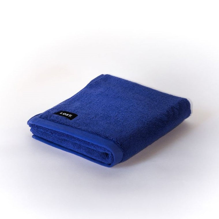 folded electric blue bath mat