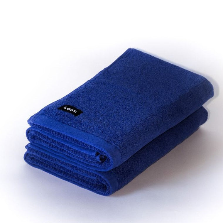 two folded electric blue bath towels