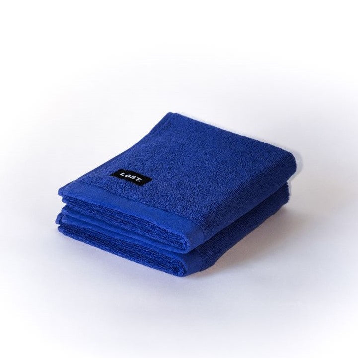 two folded electric blue hand towels