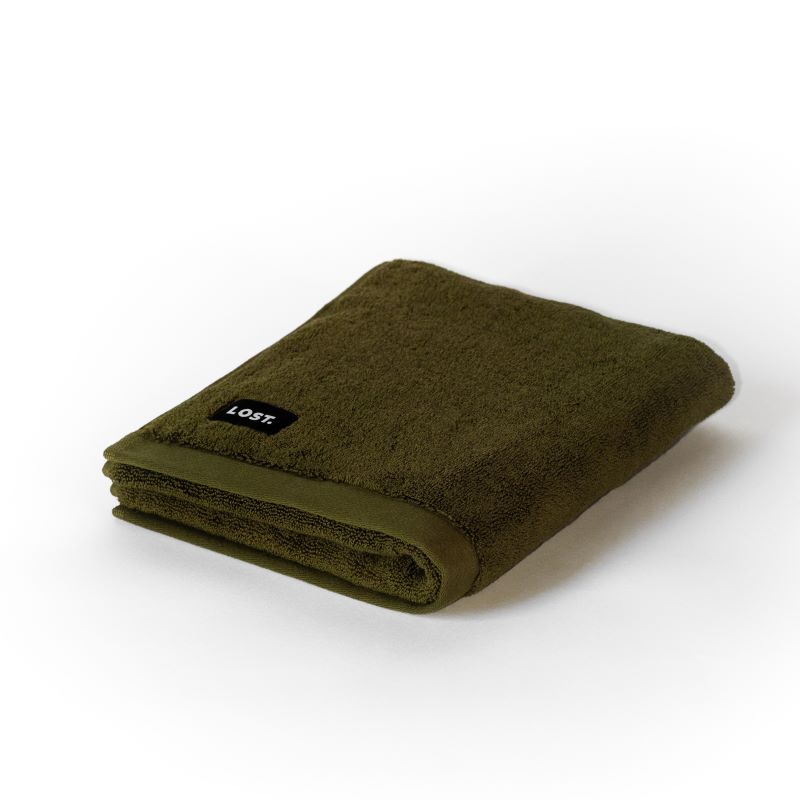 folded khaki bath mat