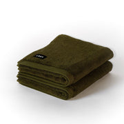 two folded khaki bath mats