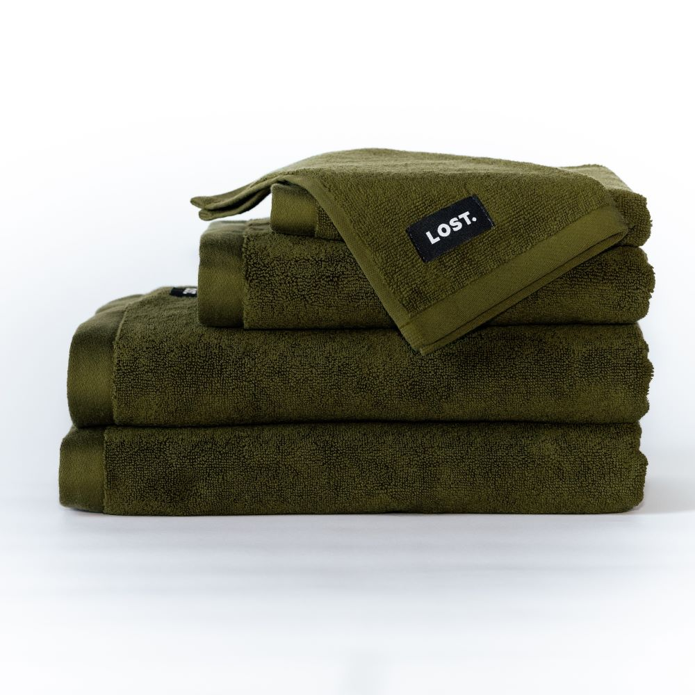 Lost Towel logo on a stack of khaki bath towels