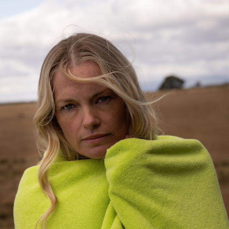 blonde woman wrapped in a chartreuse towel