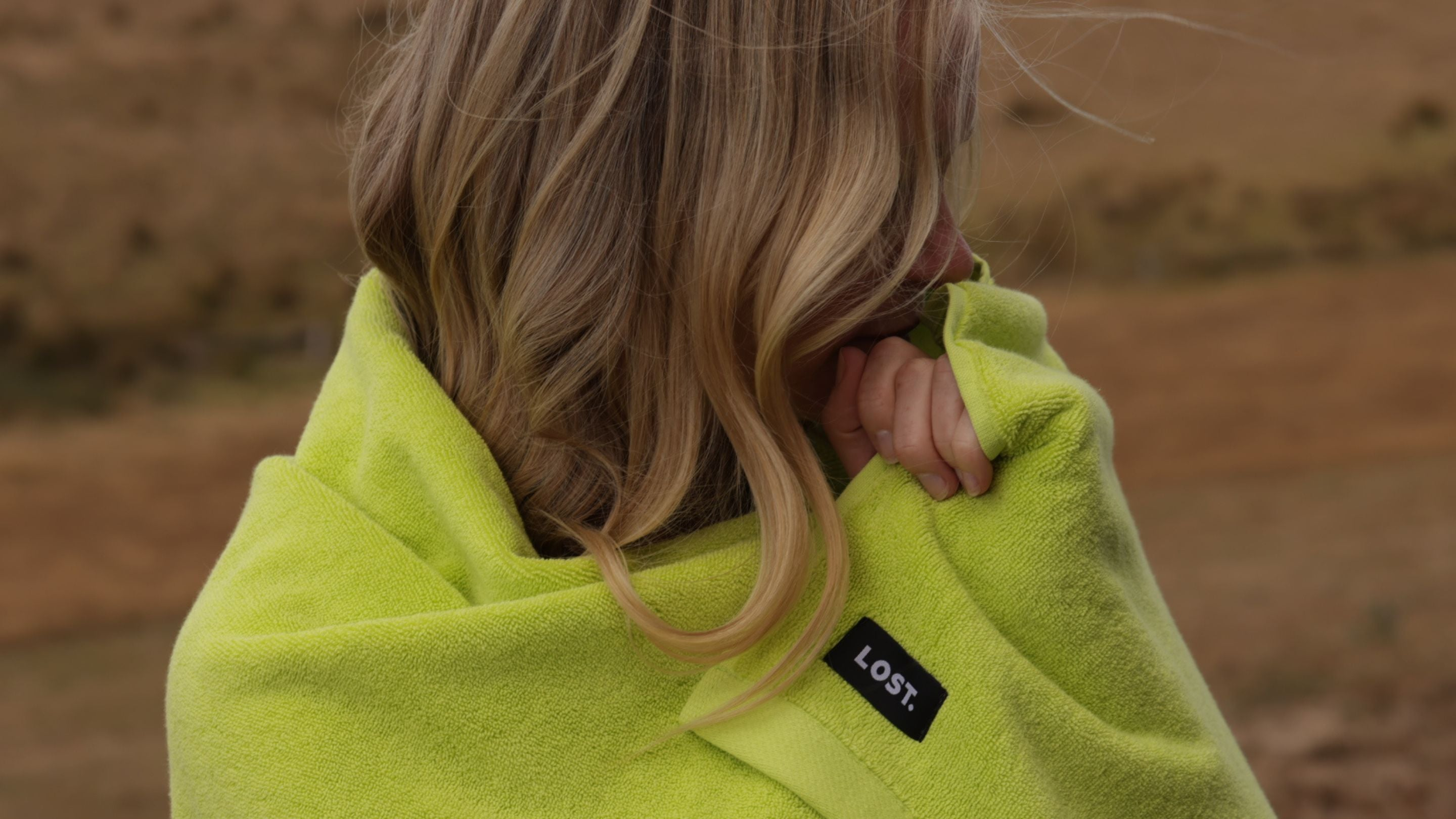 blonde woman wrapped in chartreuse towel